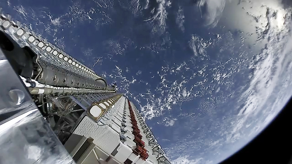 A stack of 60 Starlink satellites in orbit above Earth before deployment, May 2019
