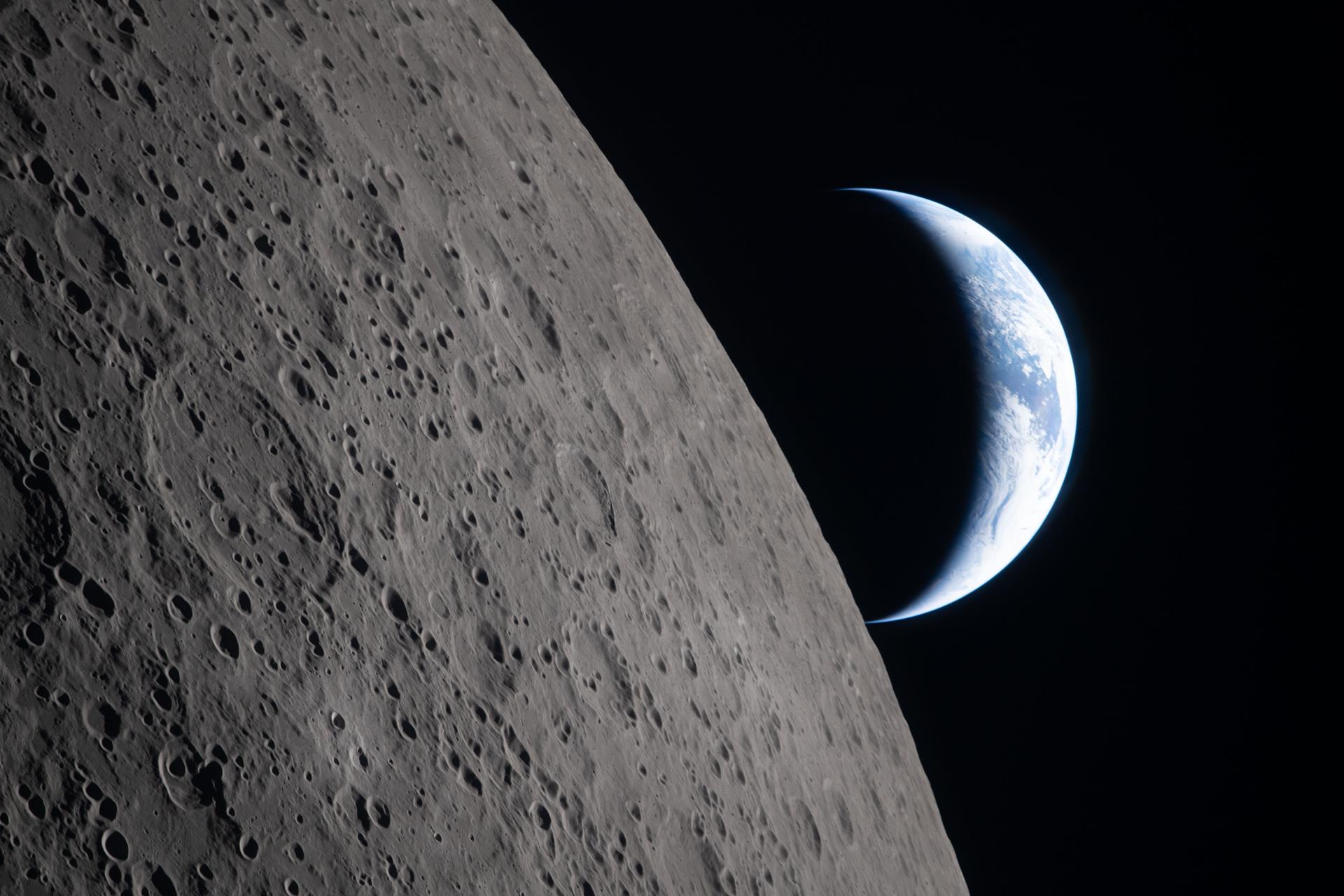 Crescent Earth setting behind the lunar limb, photographed by the Artemis II crew