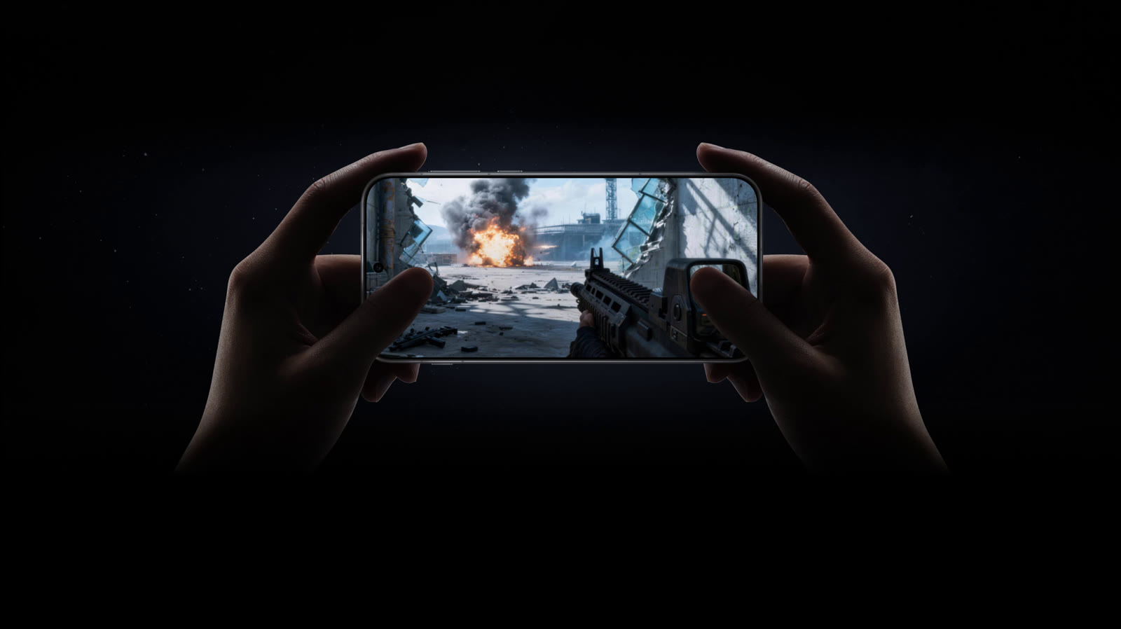Hands holding the phone sideways while playing a shooter game