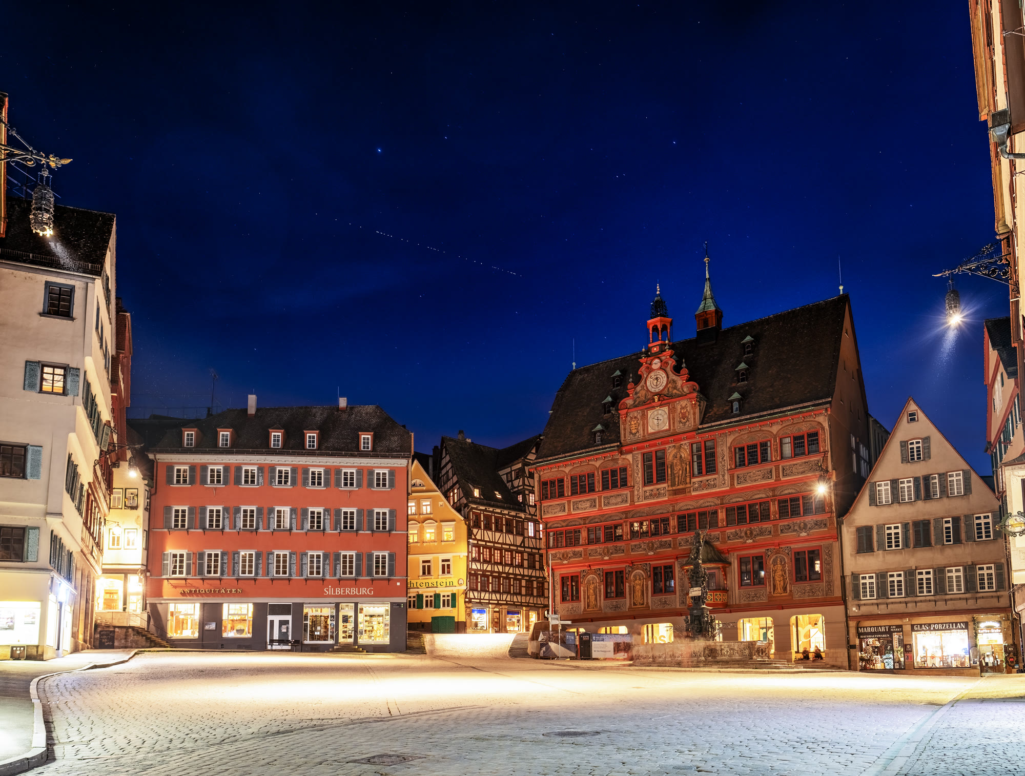 A line of Starlink satellites crossing the night sky above Tübingen town hall
