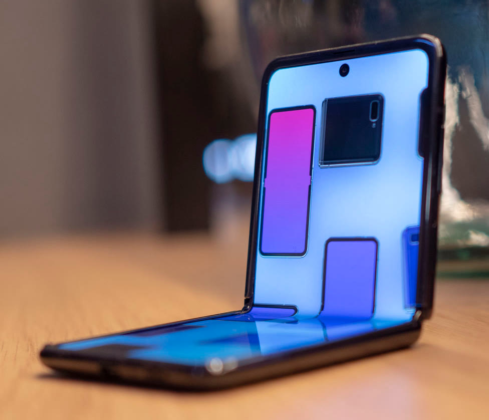 Samsung Galaxy Z Flip standing half-open at 90 degrees, its screen bending at the hinge